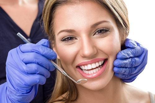 woman smiling after getting dental crowns in eagle river